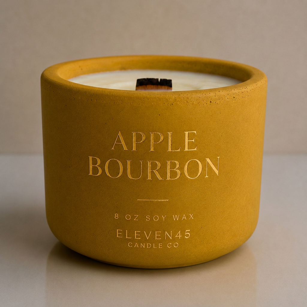 Apple Bourbon fall candle in a golden refillable concrete vessel with an unlit wooden wick