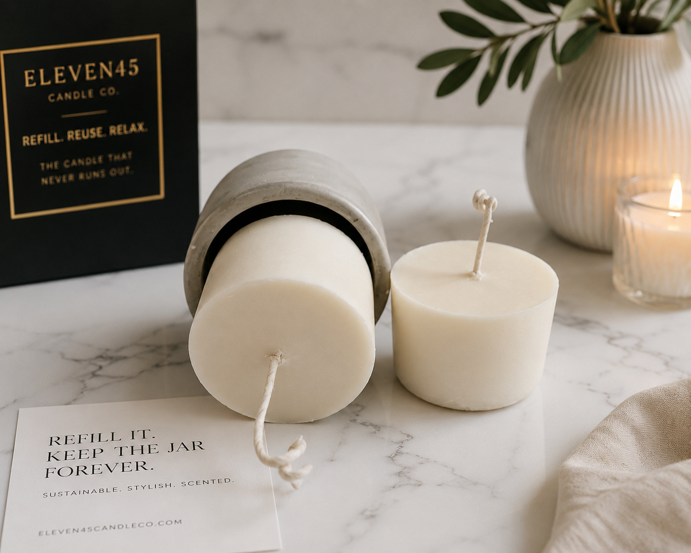 Eleven45 soy wax candle refills with concrete vessel and packaging on marble