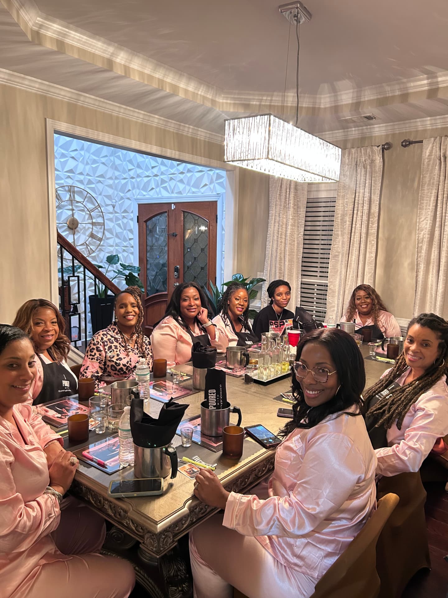 Guests in robes and aprons at a private Eleven45 candle-making party in Atlanta